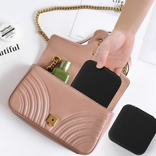 Tan zip jewelry organizer with ring slot compartments and a flat accessory pocket