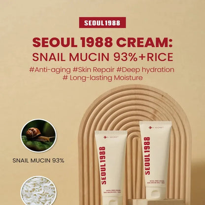 Two K-SECRET cream tubes on a bamboo display with snail and rice icons