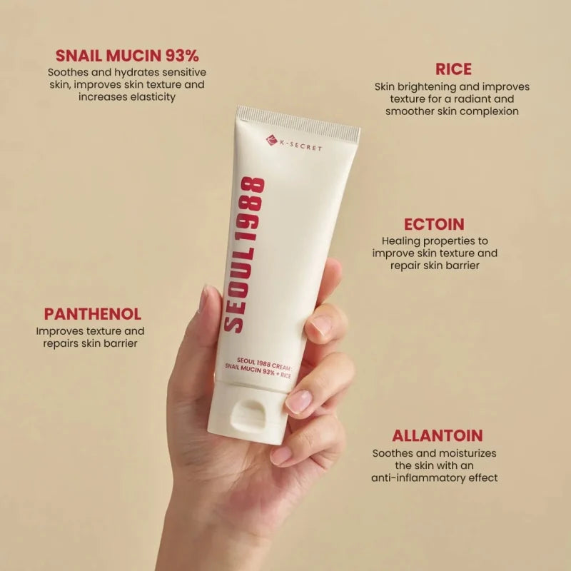 K-SECRET snail cream tube held in hand, cream-colored skincare tube