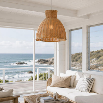 Natural rope pendant light with woven dome shade hanging near large windows