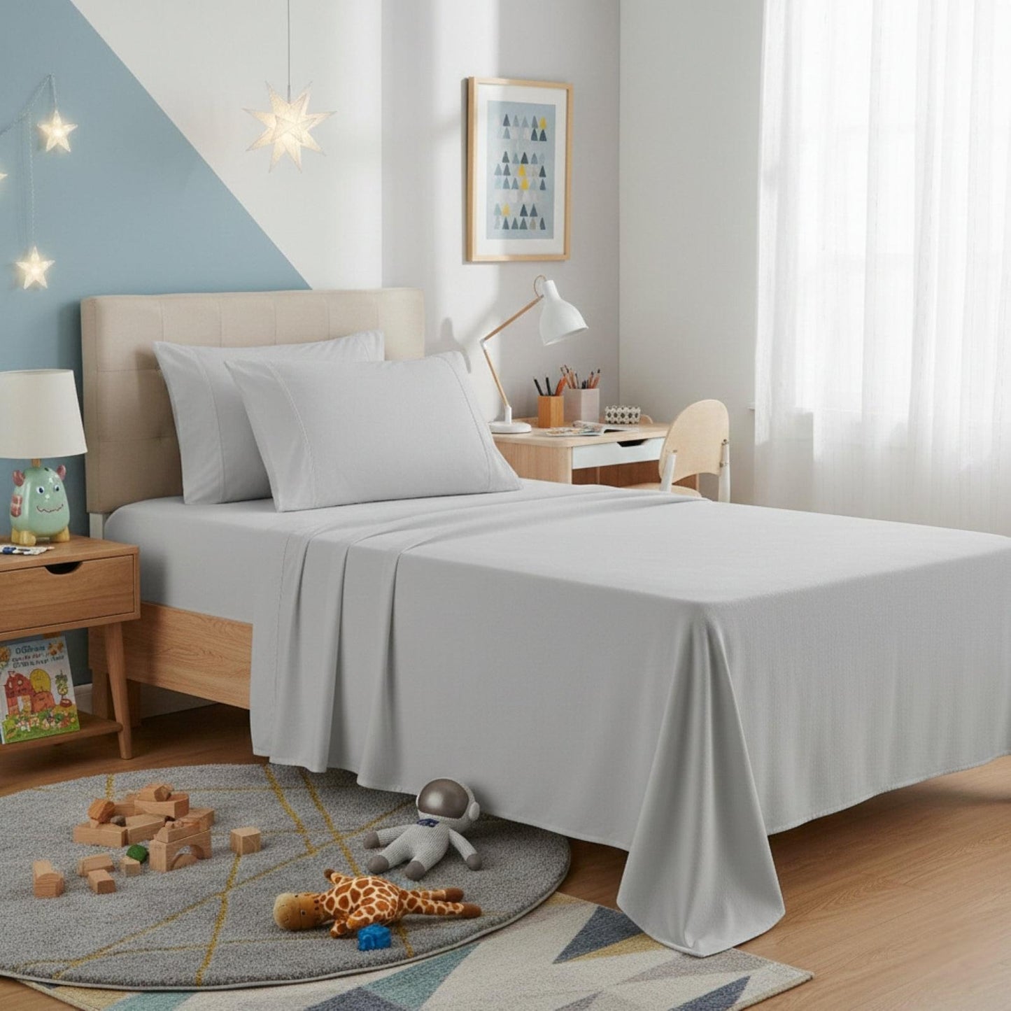 Kids flannelette sheet set in ash grey on bed with matching pillowcase