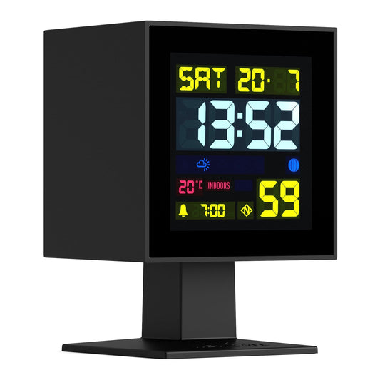 Black LCD alarm clock with screen showing SAT 20, time, indoor label, and humidity value