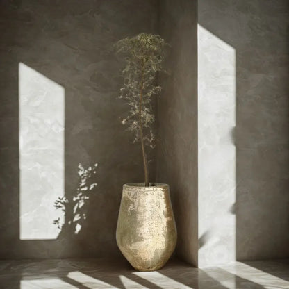 Textured speckled ceramic planter pot with leafy plant, muted gray-green finish