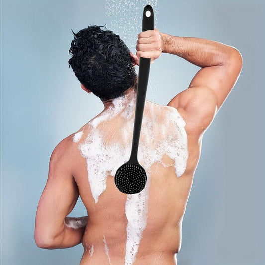 Silicone back scrub shower brush with perforated massage head, held overhead