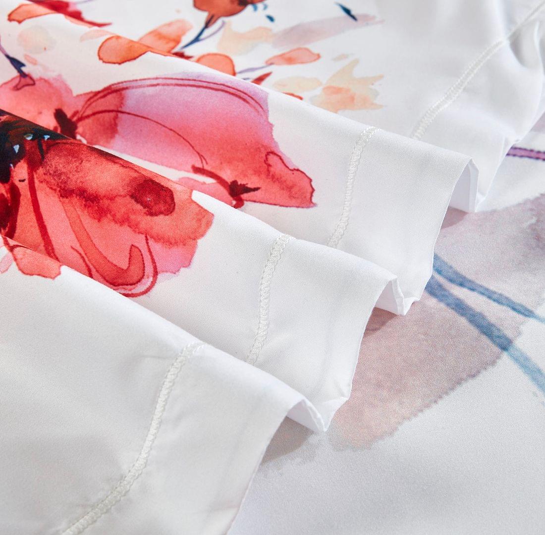 Queen floral quilt cover set fabric edge close-up with white stitching and floral print