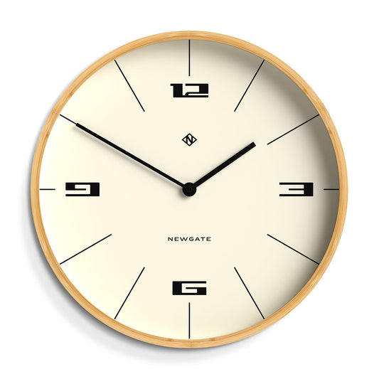 Round wall clock with light wood frame, cream dial, and black hands with hour markers