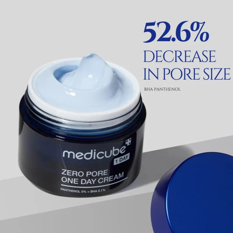 Open blue-lidded cream jar with smooth white cream inside; “medicube 1 DAY” label