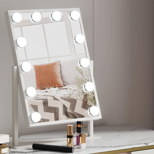 Tabletop vanity mirror with white LED bulbs around the frame and reflective glass.
