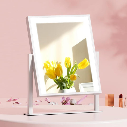 White vanity makeup mirror with LED-lit frame on standing base