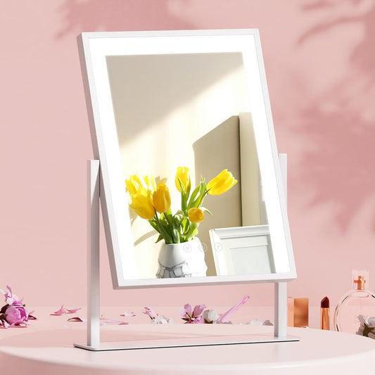 White vanity makeup mirror with LED-lit frame on freestanding base