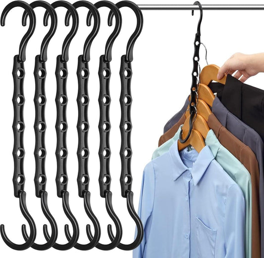 Black 6-piece pendant hanger set with curved hooks holding shirts