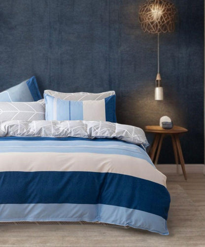 Striped quilt cover set in blue and white, shown from the side with pillow