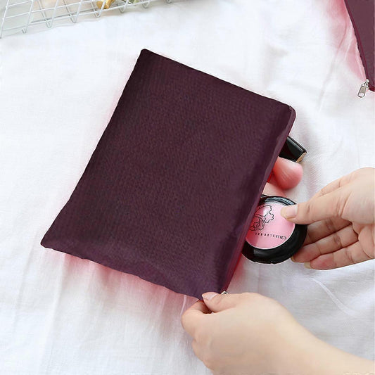 Burgundy mesh packing pouch with zipper closure holding small items
