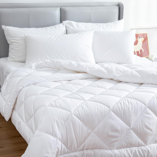 White quilt on bed, diamond quilting pattern with piped edges.