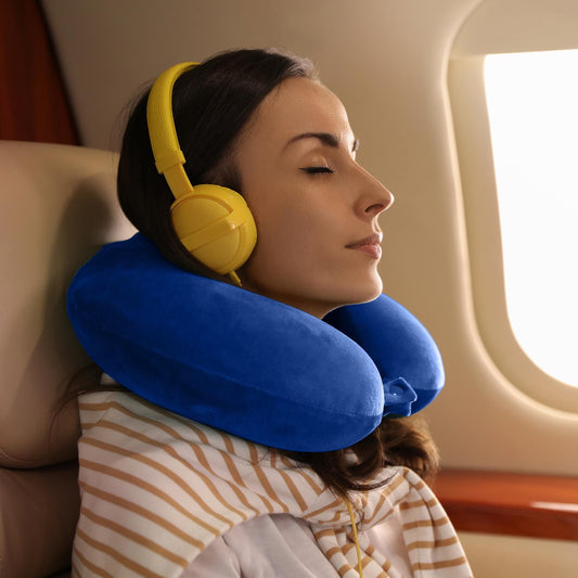 Blue U-shaped neck pillow supporting a traveler during travel