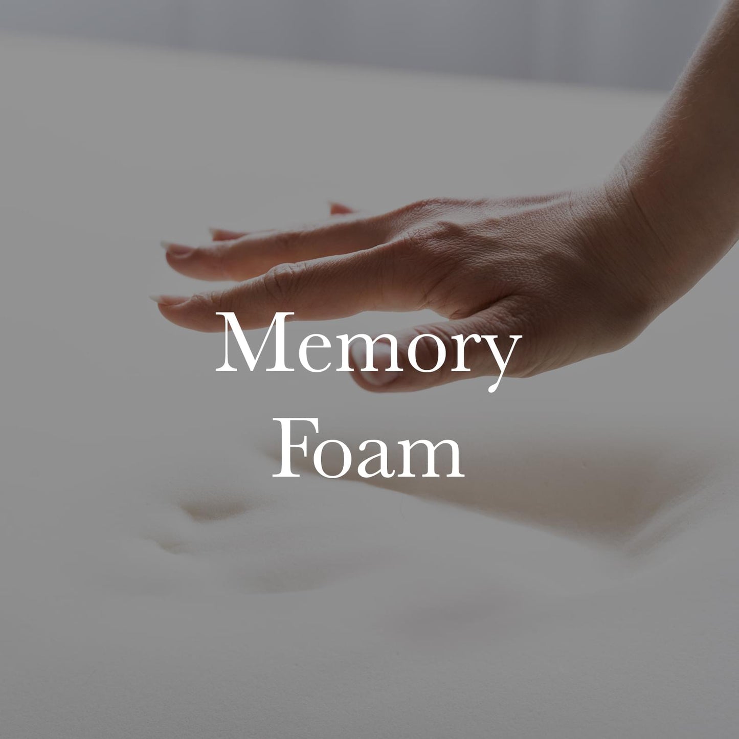 Hand pressing a grey memory-foam travel neck pillow to show cushioning