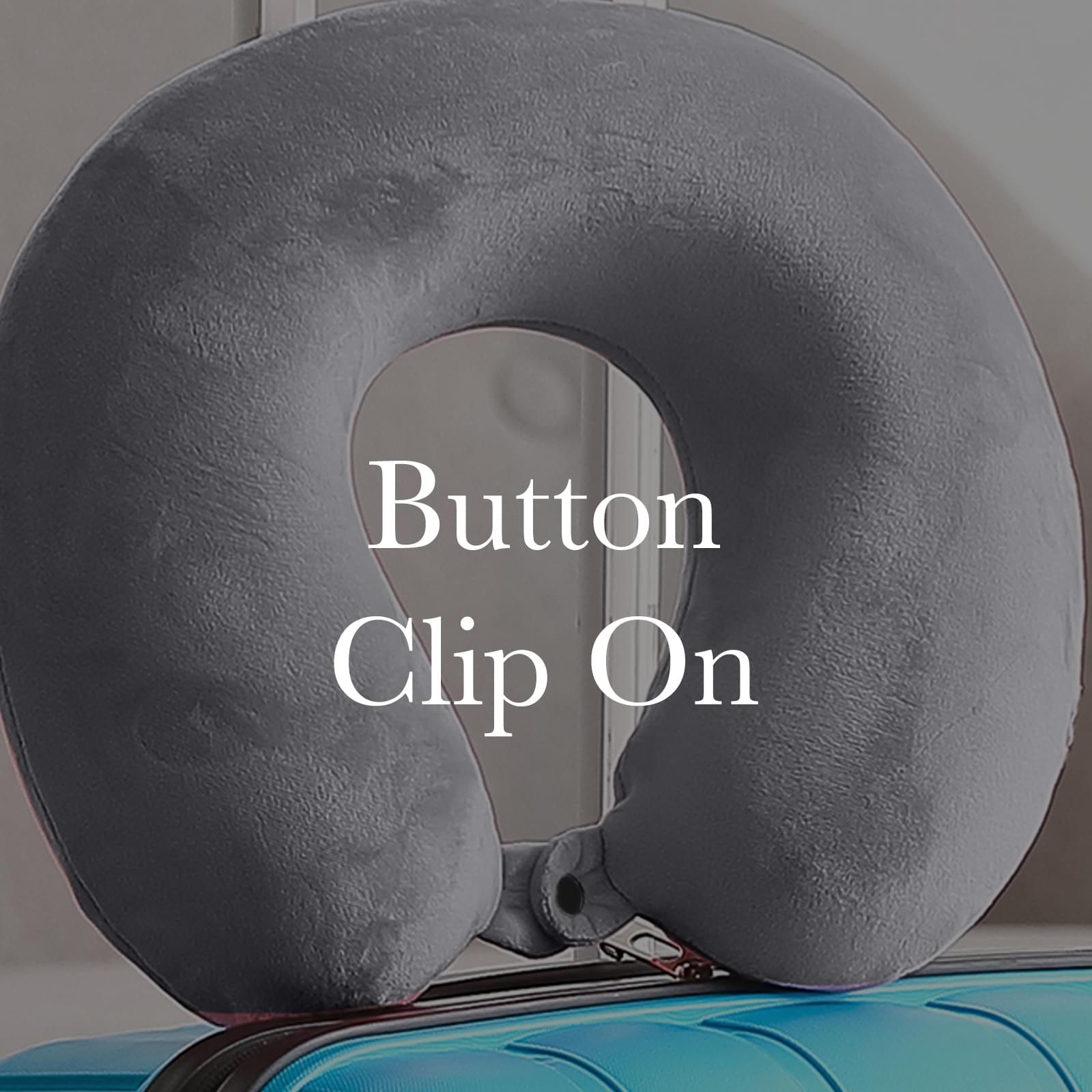 Grey travel neck pillow showing button clip attachment near center opening