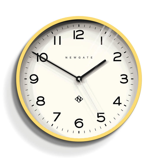 Yellow wall clock with black hour markers, twin hands, and Newgate name