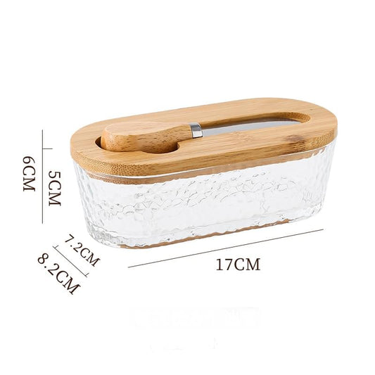 Glass butter dish with textured sides and rounded wooden lid