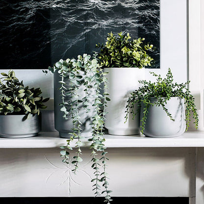Gray cylindrical planter set with three pots, round openings and straight sides.