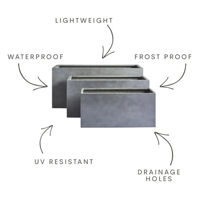 Oblong rectangular planter set in concrete grey with drainage holes
