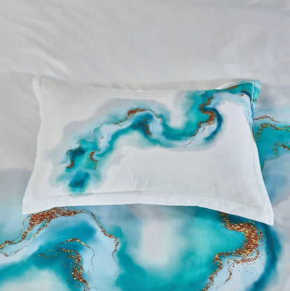 White pillow sham with teal and gold marble-like swirl pattern