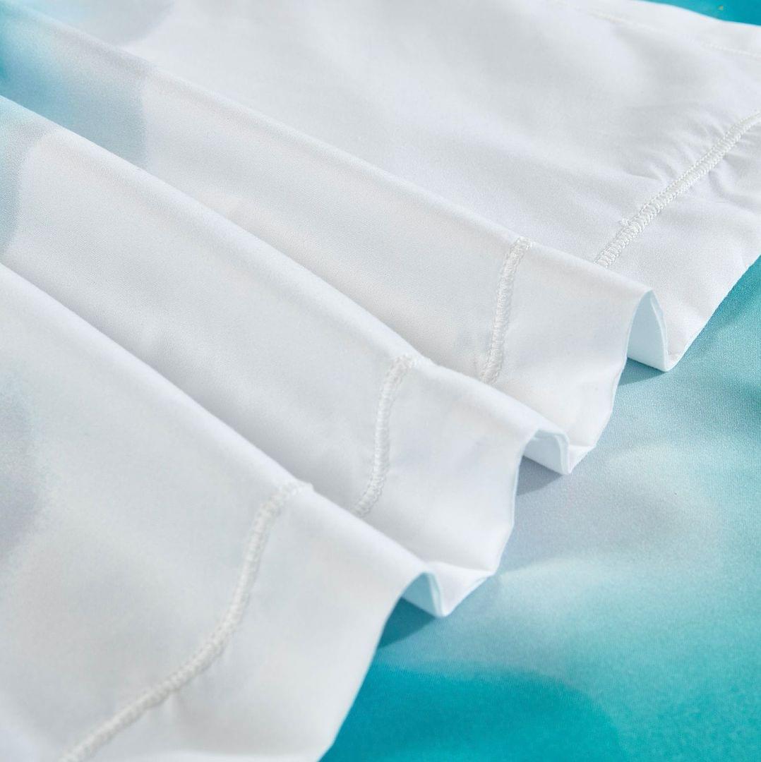 White quilt cover with ocean-blue marble pattern and stitched corner details
