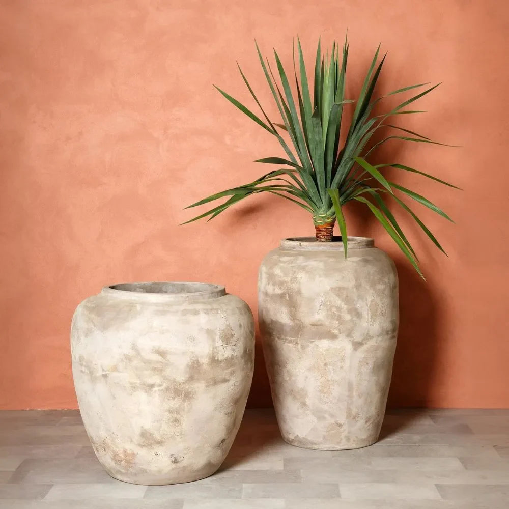 Two stone-textured planter jars with flared rims, light gray-speckled off-white.