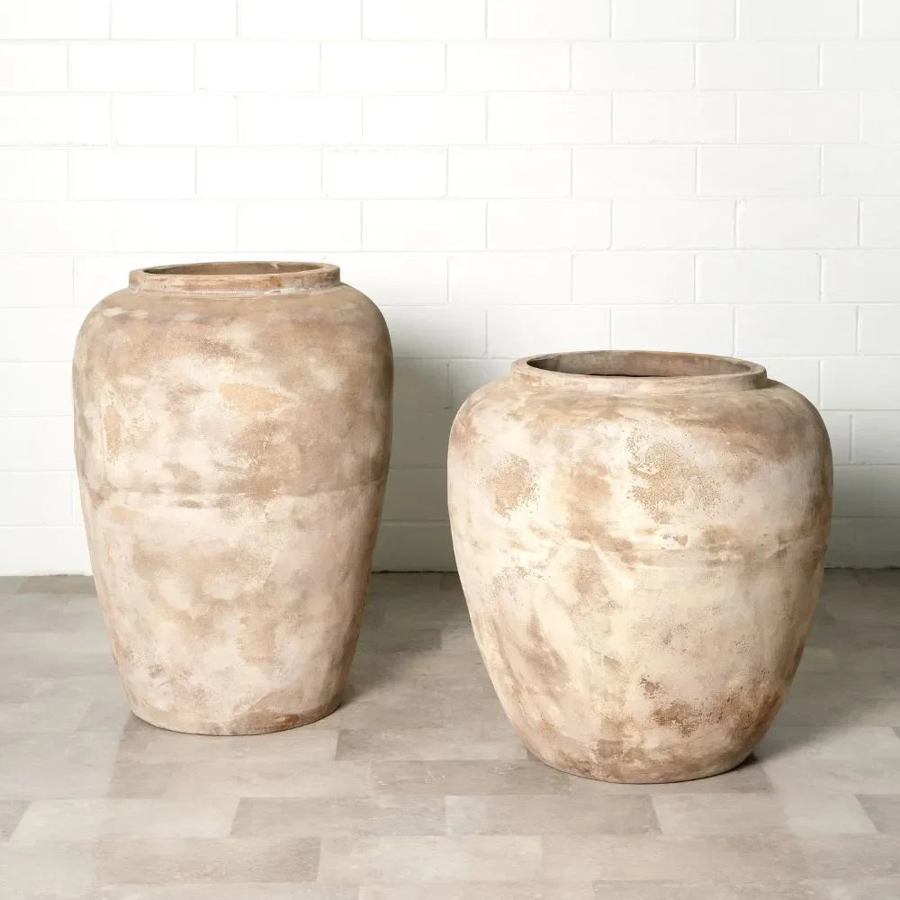 Pair of large rounded planter jars with stone texture, warm beige mottled finish.
