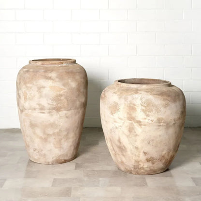 Pair of large rounded planter jars with stone texture, warm beige mottled finish.