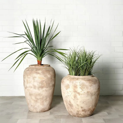 Two large stone-textured planter jars with flared rims, warm beige mottled finish.