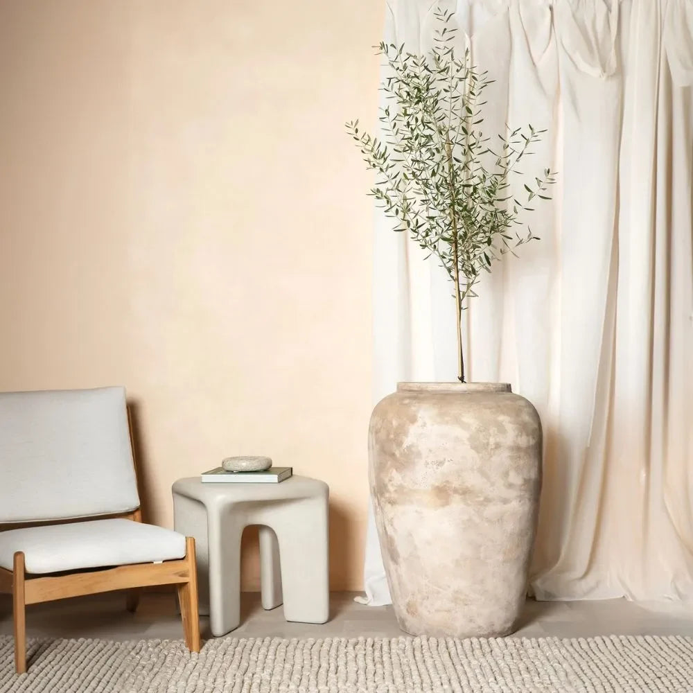 Speckled light beige olive jar with wide rounded body and short neck