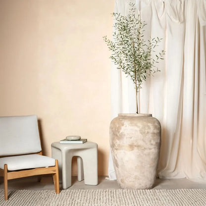 Speckled light beige olive jar with wide rounded body and short neck
