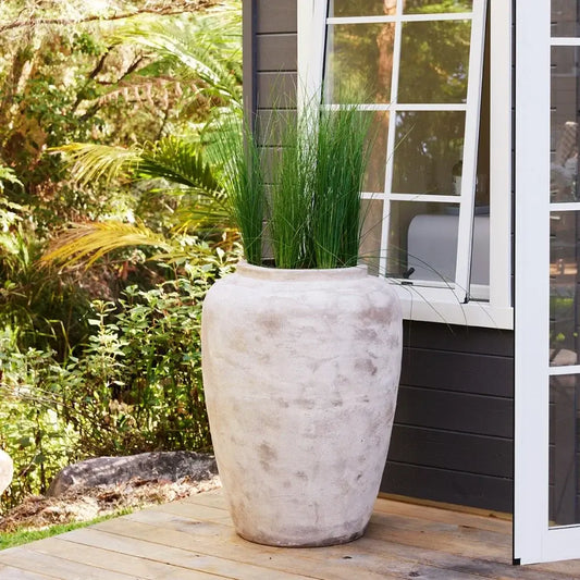 Tall stone-textured planter jar with wide round shape, off-white finish.