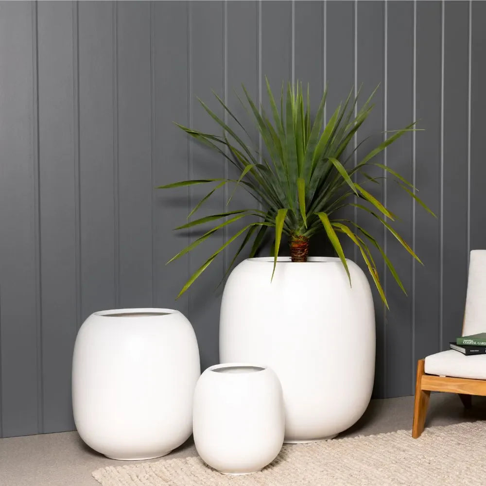 Matte white ceramic vase set of three with open tops and rounded bodies