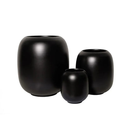 Matte black ceramic vase set of three with open tops and smooth rounded shapes