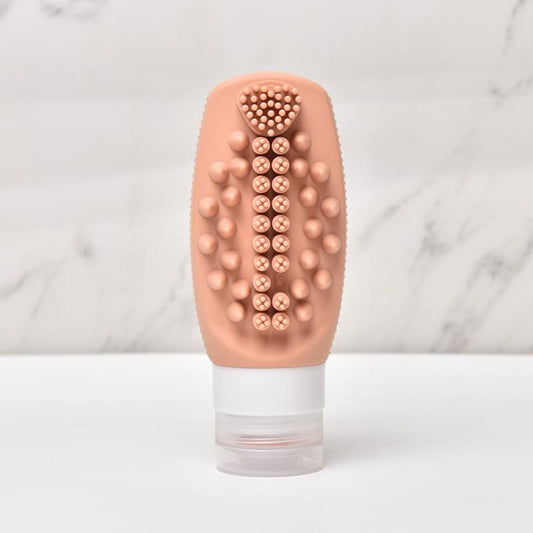 Peach silicone scalp brush head with round massage nubs and clear refill bottle