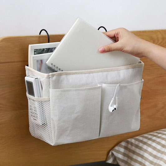 White hanging bed organizer pocket with three compartments, side mesh pocket and hooks