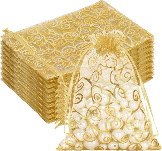 Gold sheer organza drawstring gift bag with gold swirl print, filled with pearls