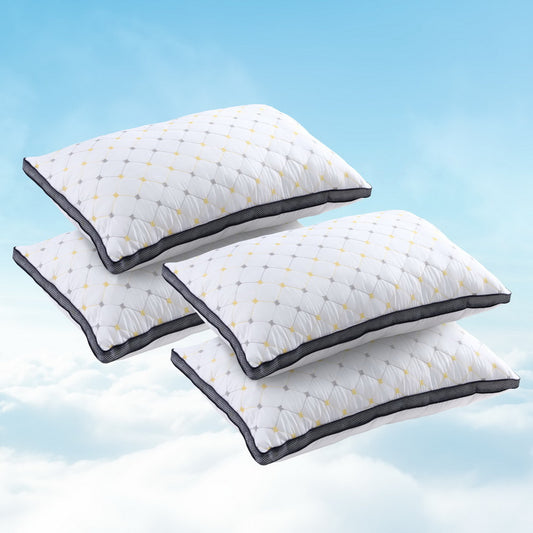 Set of white quilted microfibre pillows with gold crosshatch pattern and dark piping