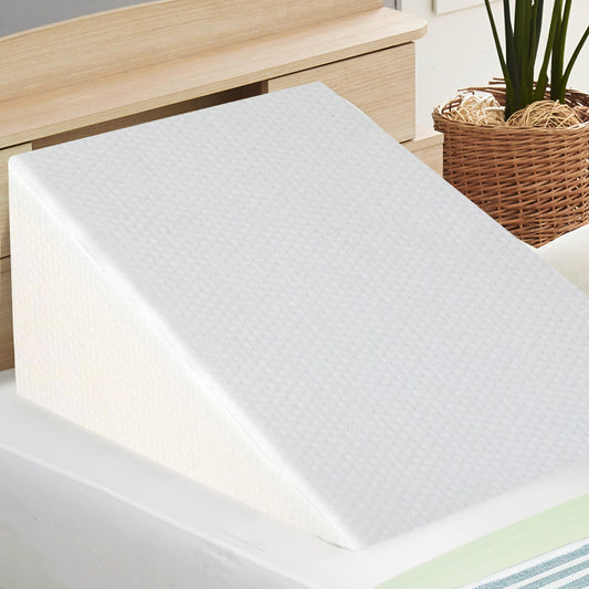 White wedge pillow with textured surface for head elevation on bed