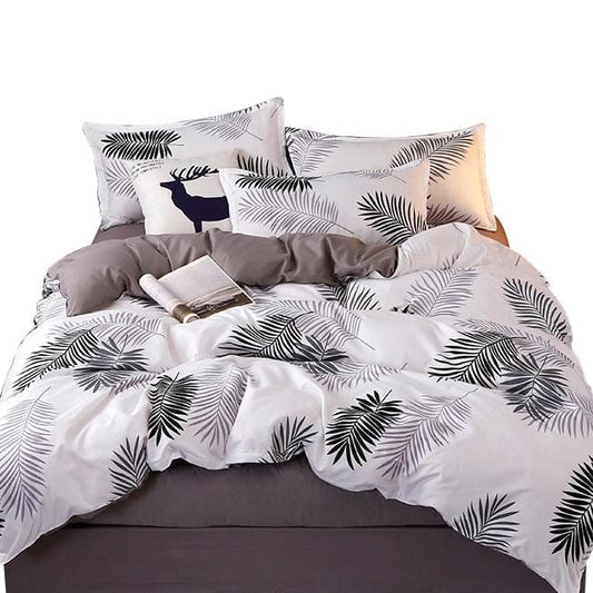 Bedding set with white and black palm leaf print pillows and matching flat sheet with gray cover