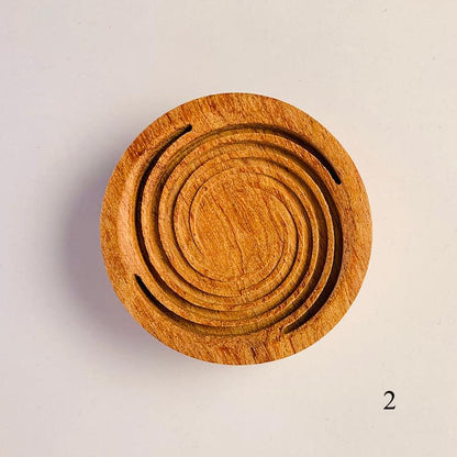 Round wooden diffuser lid with concentric ring grooves and two curved slits