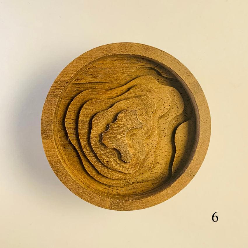 Round wooden diffuser lid with cat face cutout and textured wood grain