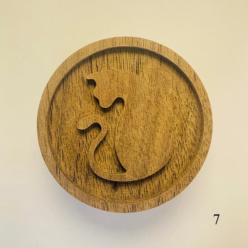Round wooden diffuser lid with carved arch shapes and curved cutout motif