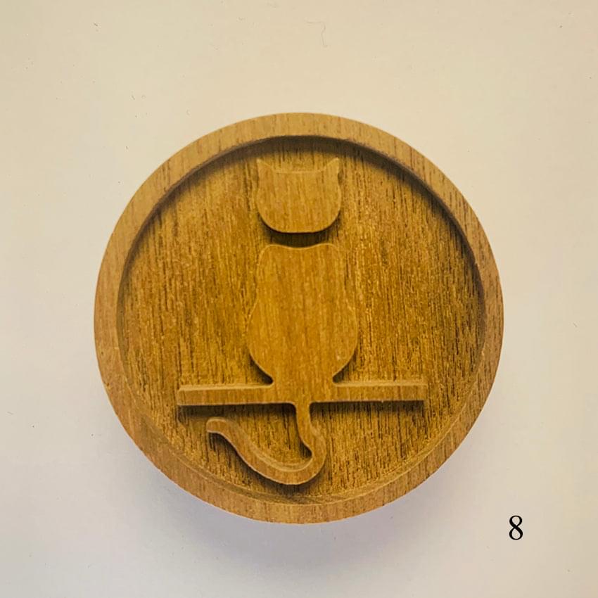Round wooden diffuser lid with carved arch shapes and curved cutout motif