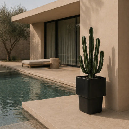 Charcoal stacked cube planter with potted cactus by a pool edge