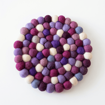 Handmade wool felt trivet with raised purple, violet, lilac, and cream balls