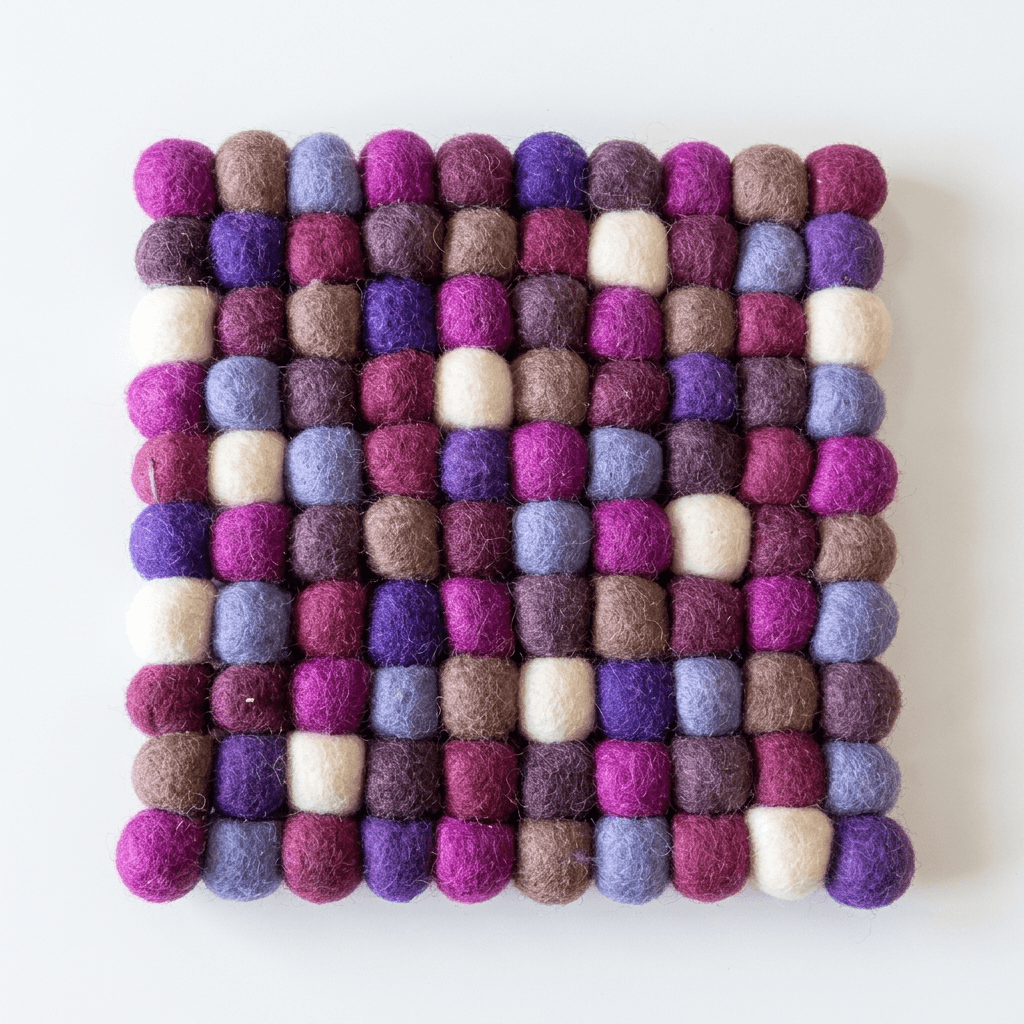 Square wool felt heat mat with raised multi-color ball pattern in plum, violet, and cream