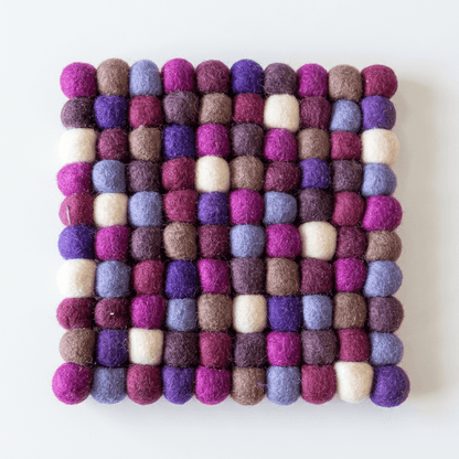 Square wool felt heat mat with raised multi-color ball pattern in plum, violet, and cream